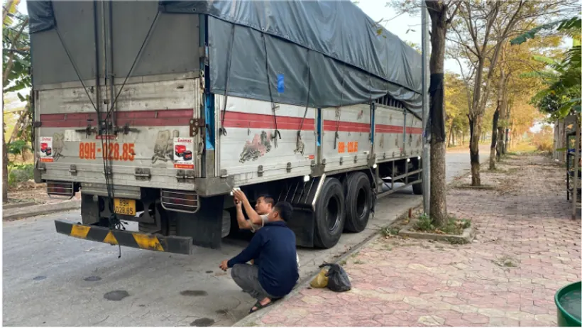Nhân viên kiểm tra xe tải trước khi vận chuyển
